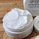Open jar of Vitality Rose Night Crème showing smooth white cream texture.