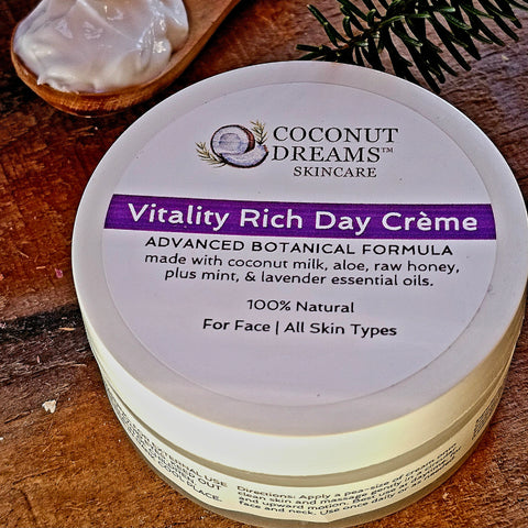 Coconut Dreams Skincare Vitality Rich Day Crème jar with mint and lavender label on wooden surface.