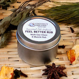 Metal tin of Coconut Dreams Skincare rub styled on woven mat with dried herbs and spices.