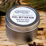 Coconut Dreams Skincare Feel Better Rub in metal tin displayed on woven surface with dried botanicals.