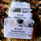 Coconut Dreams Skincare solid shampoo bars stacked in paper wrapping with botanical pattern.