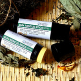 Coconut Dreams Skincare sun rescue stick SPF 30 displayed on woven surface with dried botanicals.