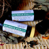 Two sun rescue stick SPF 30 mineral sunscreen tubes with one opened to show balm.