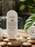 Coconut Dreams Skincare frankincense body cream bottle displayed on smooth stones with rolled towels and greenery.